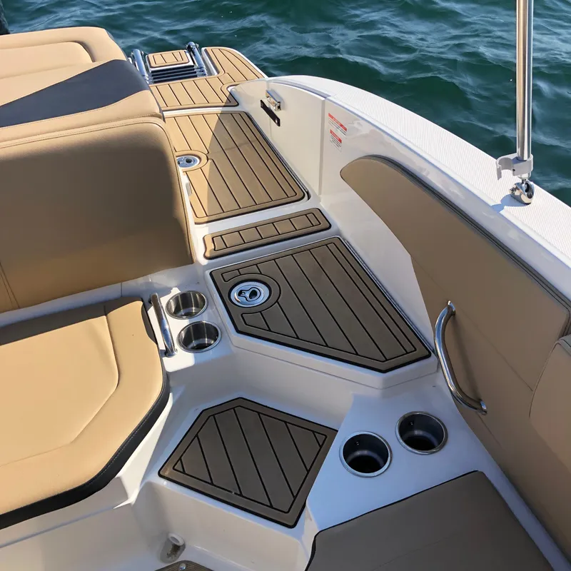 Slide: The Image of The image shows the deck of a Sea Ray SPX 210 Outboard boat with beige upholstery. - 5