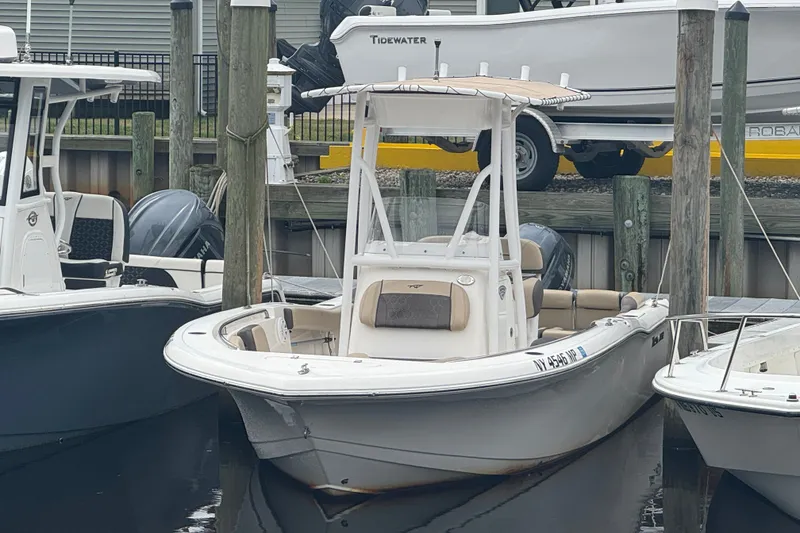 The Image of 2019 Tidewater 210 LXF boat docked at a marina, featuring a sleek design. - 1