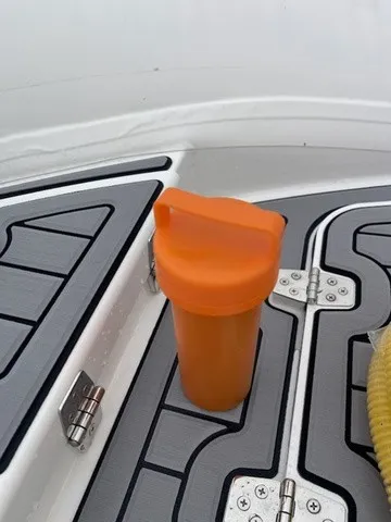 Slide: The Image of An orange cup sits on the floor of a Zodiac Nomad Rib Alu 2.7 boat. - 19