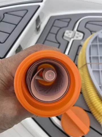 Slide: The Image of Close-up of an orange hose on a boat with a gray deck. - 20