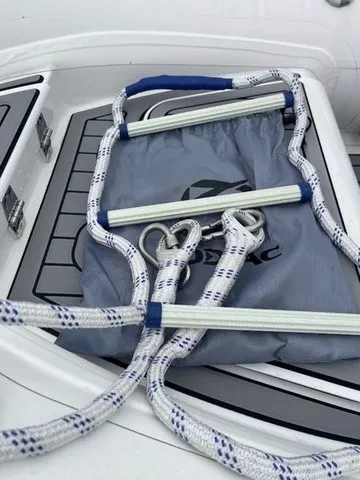 Slide: The Image of A 2027 Zodiac Nomad Rib Alu 2.7 with a rope ladder on the deck. - 21