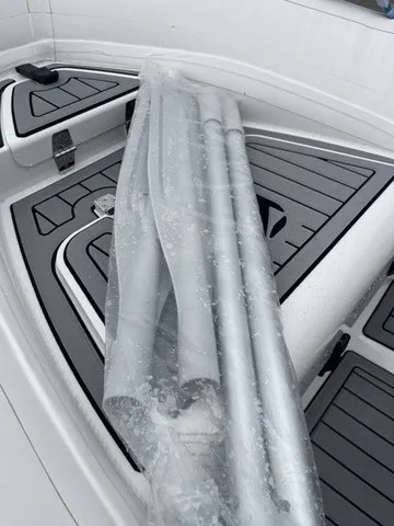Slide: The Image of The image shows the deck of a Zodiac Nomad Rib Alu 2.7 boat with gray cushions. - 22