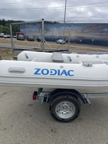 Slide: The Image of A Zodiac Nomad Rib Alu 2.7 inflatable boat on a trailer, parked in a lot. - 4
