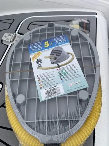 Slide: The Image of A gray, oval object with a yellow hose is on a boat. A label is attached. - 18