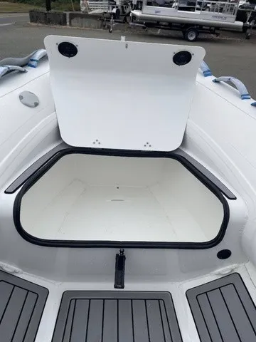 Slide: The Image of A 2027 Zodiac Nomad Rib Alu 2.7 with an open storage compartment in the bow area. - 10