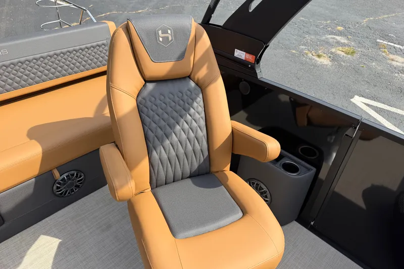 Slide: The Image of Luxurious seating on 2027 Harris Sunliner 250 boat, featuring tan and gray upholstery. - 14