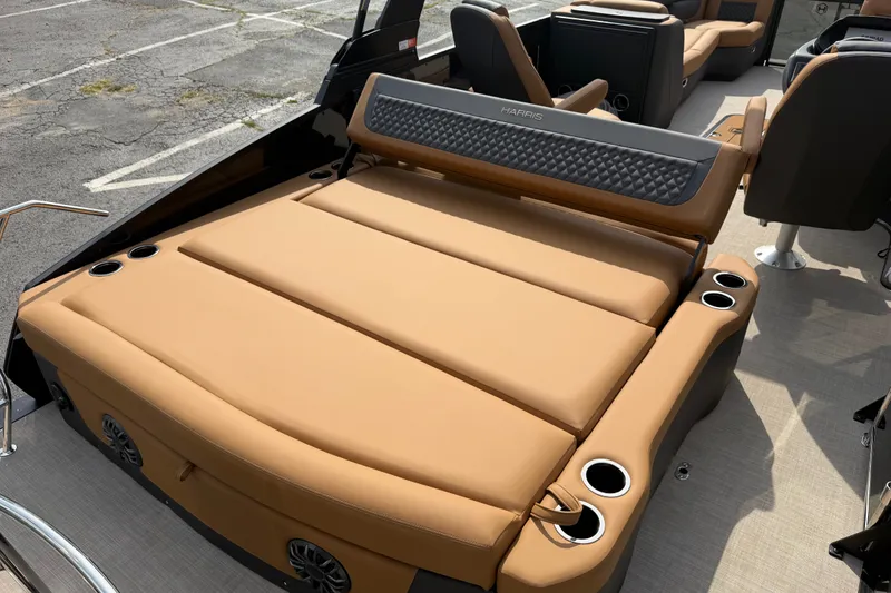 Slide: The Image of 2027 Harris Sunliner 250 boat interior with tan seating and cup holders. - 16