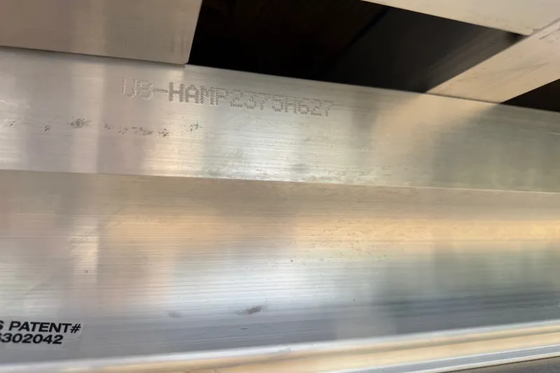 Slide: The Image of Close-up of Harris Sunliner 250, 2027 model, showing metal surface with engraved serial number. - 26