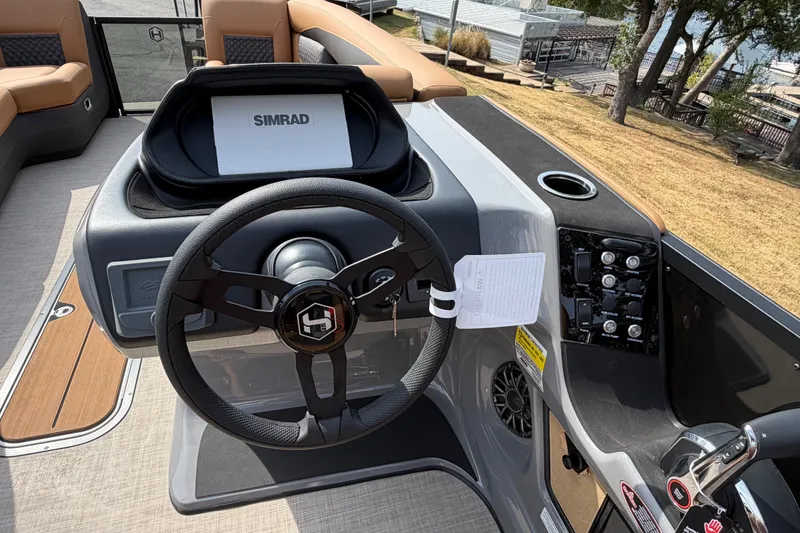 Slide: The Image of Steering console of 2027 Harris Sunliner 250 boat with Simrad display. - 20