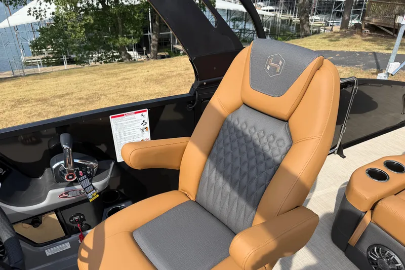 Slide: The Image of Captain's chair on 2027 Harris Sunliner 250 boat, featuring tan and gray upholstery. - 13