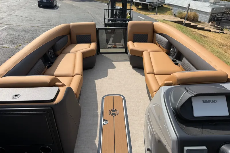 Slide: The Image of Luxurious interior of 2027 Harris Sunliner 250 pontoon boat with tan seating and modern dashboard. - 9