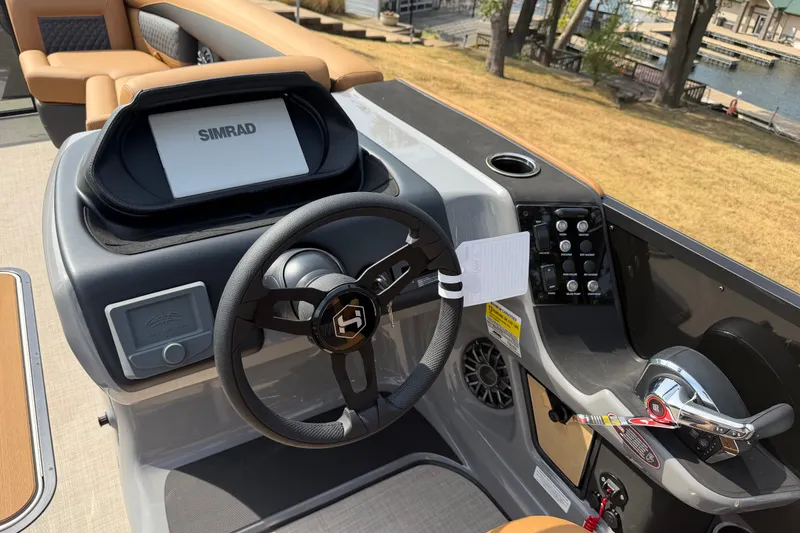 Slide: The Image of 2027 Harris Sunliner 250 boat dashboard with steering wheel and Simrad display. - 10