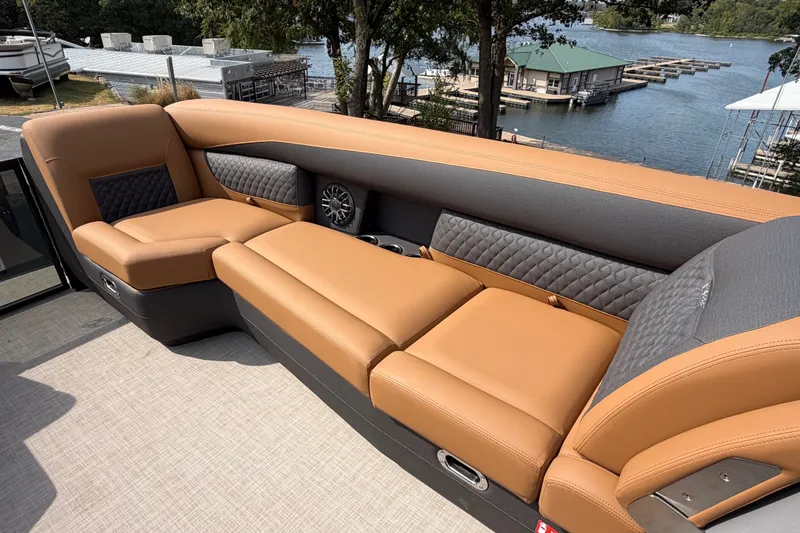 Slide: The Image of Luxurious seating on 2027 Harris Sunliner 250 boat, overlooking a serene marina. - 21