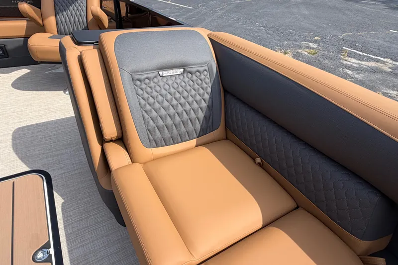 Slide: The Image of Luxurious seating on 2027 Harris Sunliner 250 boat, featuring tan and gray upholstery with quilted design. - 23