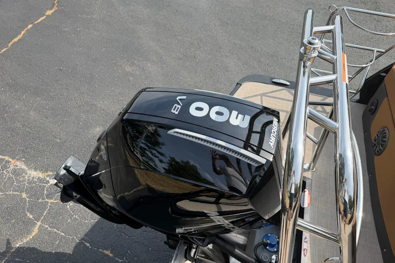 Slide: The Image of 2027 Harris Sunliner 250 with Mercury 400 V8 outboard engine, docked on asphalt. - 17