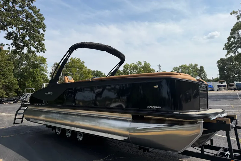 Slide: The Image of 2027 Harris Sunliner 250 pontoon boat on trailer, parked outdoors. - 6