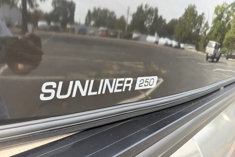Slide: The Image of 2027 Harris Sunliner 250 logo on a reflective surface with outdoor background. - 7