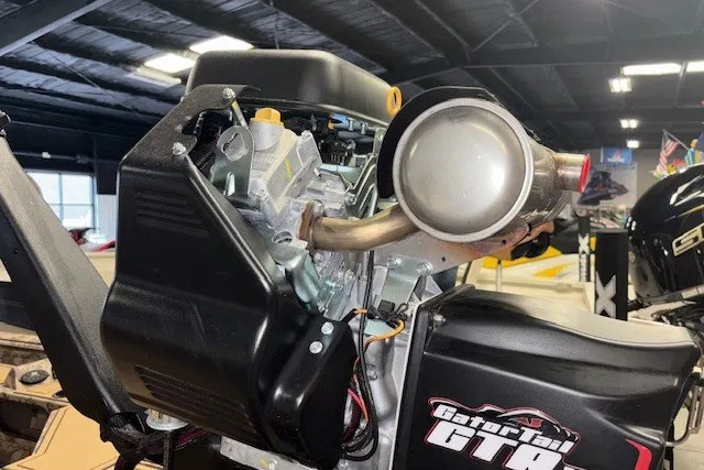 Slide: The Image of Outboard motor detail on 2026 Xpress Bayou 180 boat in showroom setting. - 7