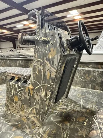 Slide: The Image of The image shows the cockpit of a War Eagle 2170 Blackhawk boat with camouflage pattern. - 13