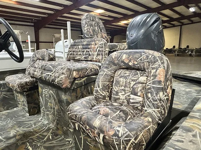Slide: The Image of The image shows a 2027 War Eagle 2170 Blackhawk boat with camo-patterned seats in a warehouse. - 14