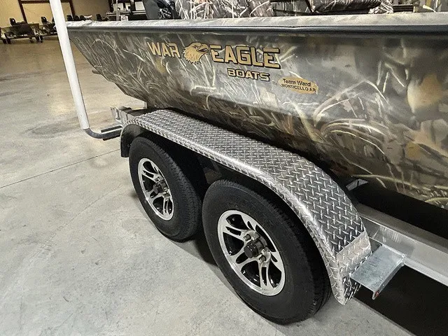 Slide: The Image of A War Eagle 2170 Blackhawk boat on a trailer with camouflage pattern and sturdy tires. - 10