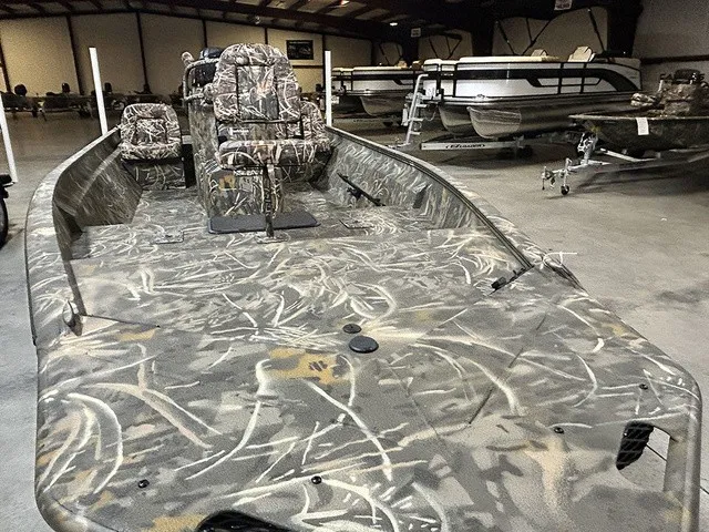 Slide: The Image of The image shows a 2027 War Eagle 2170 Blackhawk boat with a camouflage interior. - 4