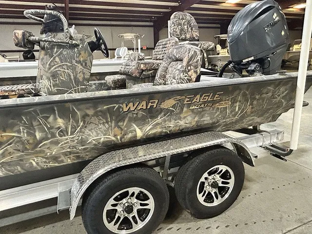 Slide: The Image of War Eagle 2170 Blackhawk 2027 with camouflage design and powerful outboard motor on a trailer. - 15