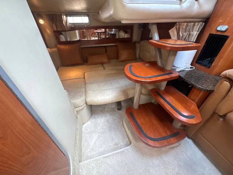 Slide: The Image of Interior of a 2006 Four Winns 318 Vista with elegant wood accents and comfortable seating. - 13