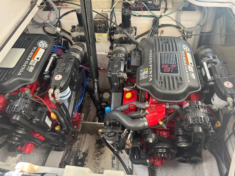 Slide: The Image of Two Volvo Penta engines in a boat's engine compartment, surrounded by wires and hoses. - 17