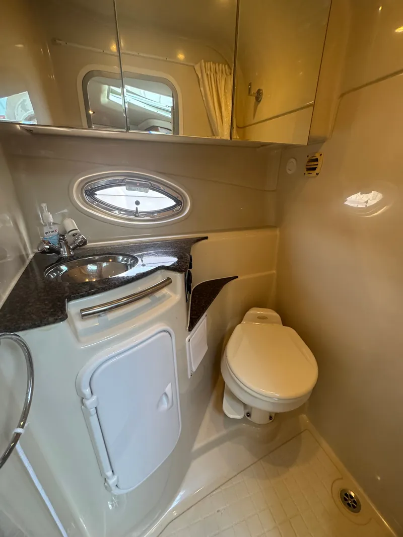 Slide: The Image of The image shows a sleek yacht bathroom with a sink, toilet, and mirror. - 15