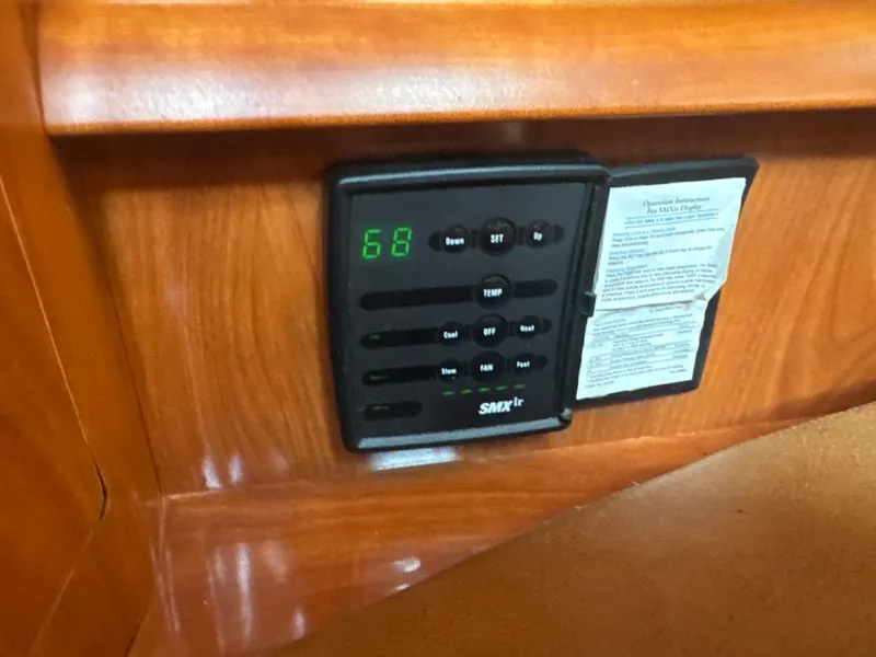 Slide: The Image of A control panel with digital display and buttons on a wooden panel. - 16