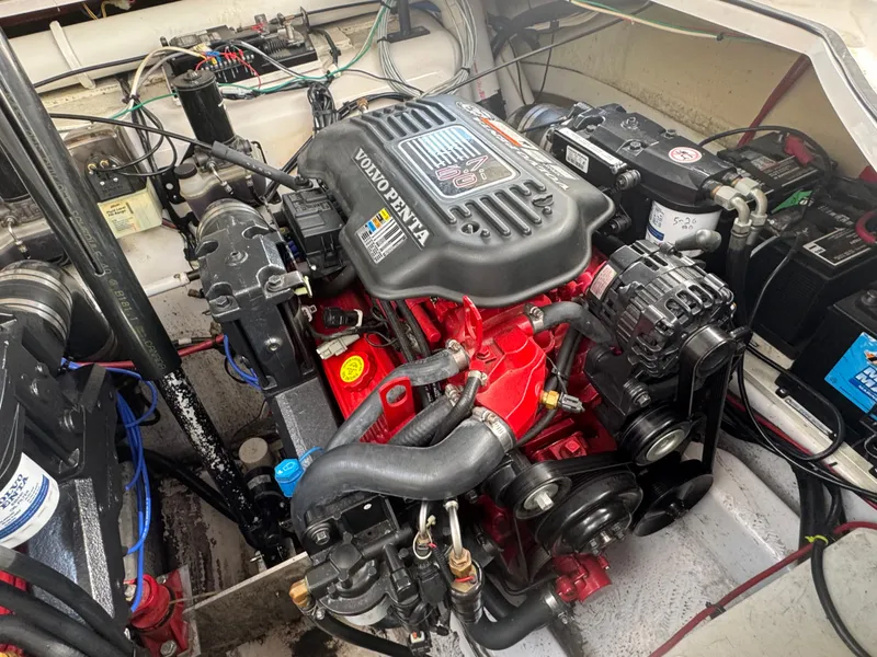 Slide: The Image of A Volvo Penta engine in a boat, surrounded by cables and batteries. - 19