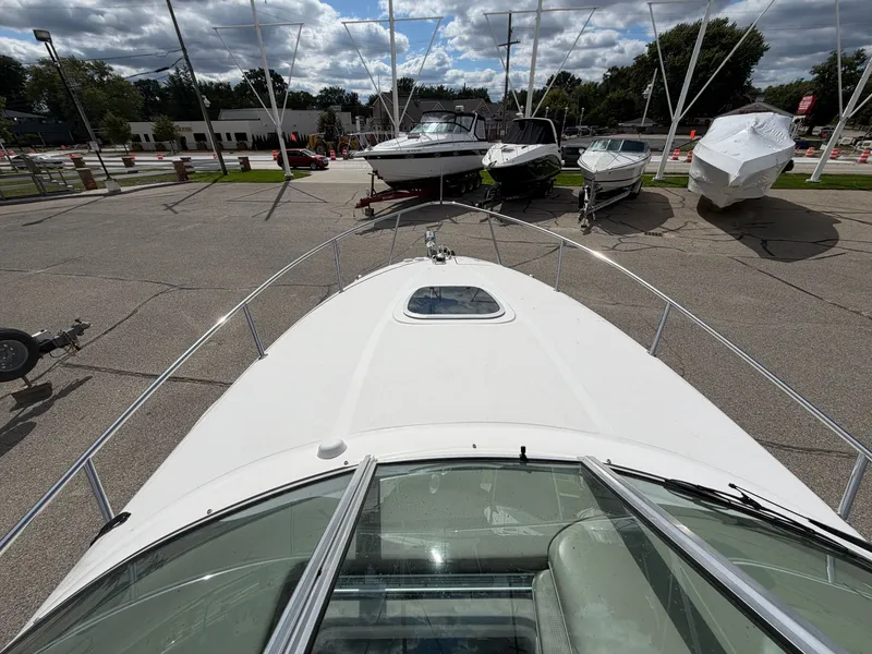 Slide: The Image of The 2006 Sea Ray Sundancer 260 is parked on a lot with other boats. - 10