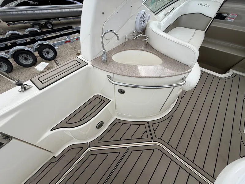 Slide: The Image of The image shows the cockpit of a 2006 Sea Ray Sundancer 260 with sleek seating and a small sink. - 5