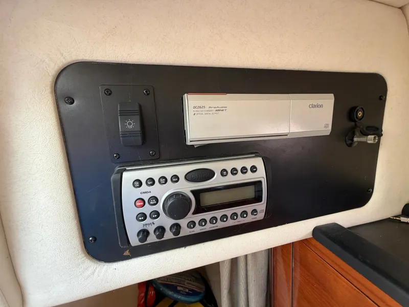 Slide: The Image of A control panel with a Clarion audio system and controls in a 2006 Sea Ray Sundancer 260. - 15