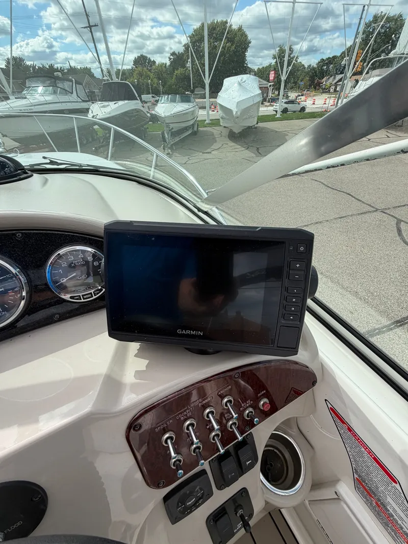 Slide: The Image of The image shows the cockpit of a 2006 Sea Ray Sundancer 260 with a Garmin navigation system. - 9