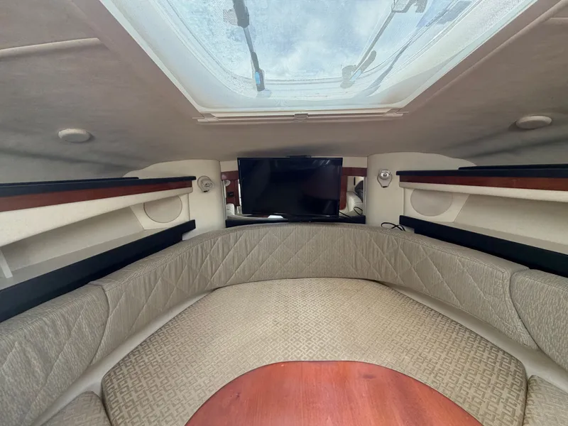 Slide: The Image of Interior of a 2006 Sea Ray Sundancer 260 with cozy seating and skylights. - 12