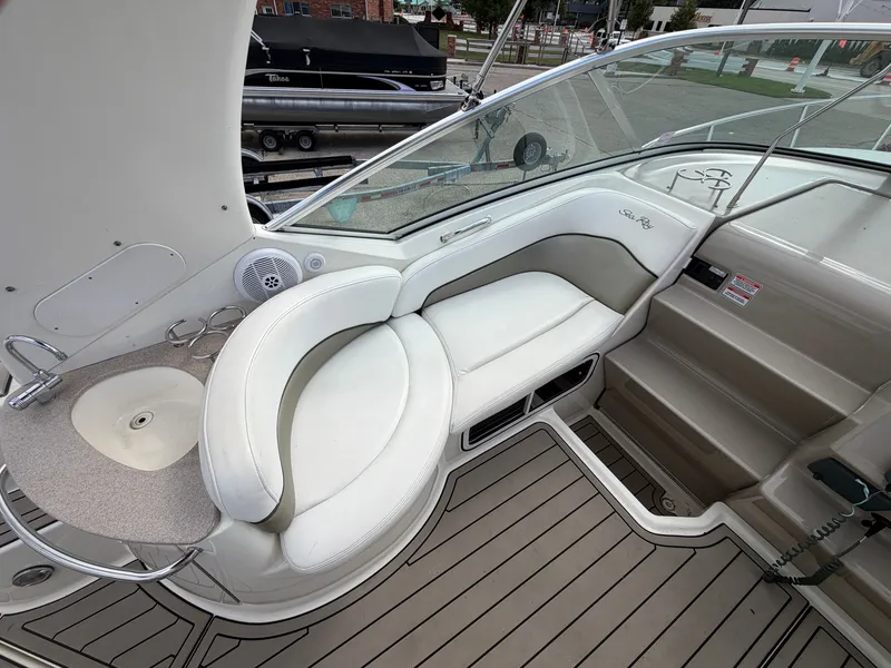 Slide: The Image of The image shows the cockpit of a 2006 Sea Ray Sundancer 260 with white seating and a sink. - 7