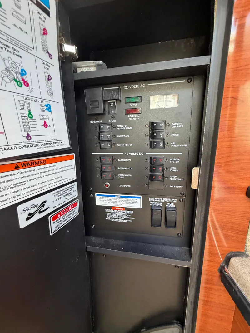 Slide: The Image of Electrical control panel inside a 2006 Sea Ray Sundancer 260. - 16