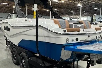 Slide: The Image of 2026 Malibu M230 boat in showroom, featuring sleek design and modern amenities. - 3