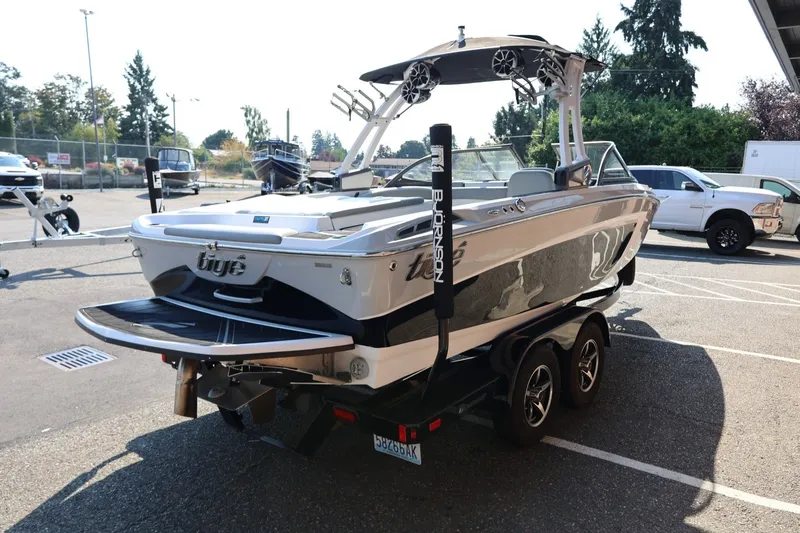 Slide: The Image of 2020 Tigé R20 boat on trailer, parked outdoors, showcasing sleek design and modern features. - 8