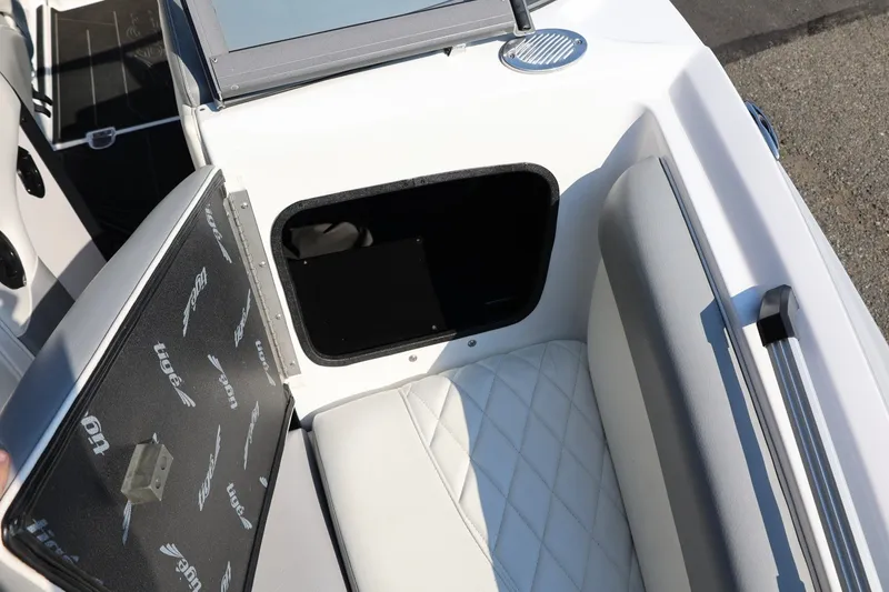 Slide: The Image of 2020 Tigé R20 boat interior with open storage compartment and cushioned seating. - 48