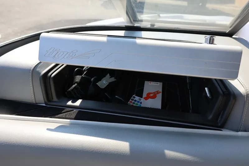 Slide: The Image of 2020 Tigé R20 boat dashboard storage compartment with accessories inside. - 33