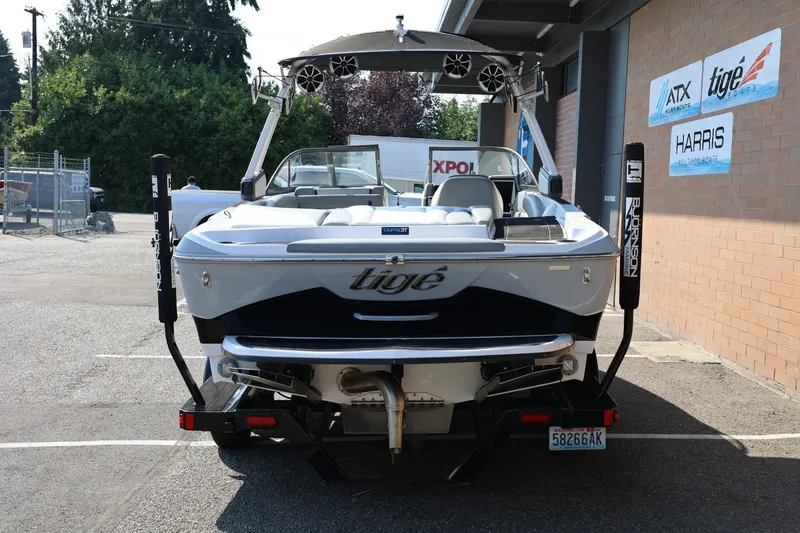 Slide: The Image of 2020 Tigé R20 boat parked outside dealership, rear view with branding and equipment visible. - 5