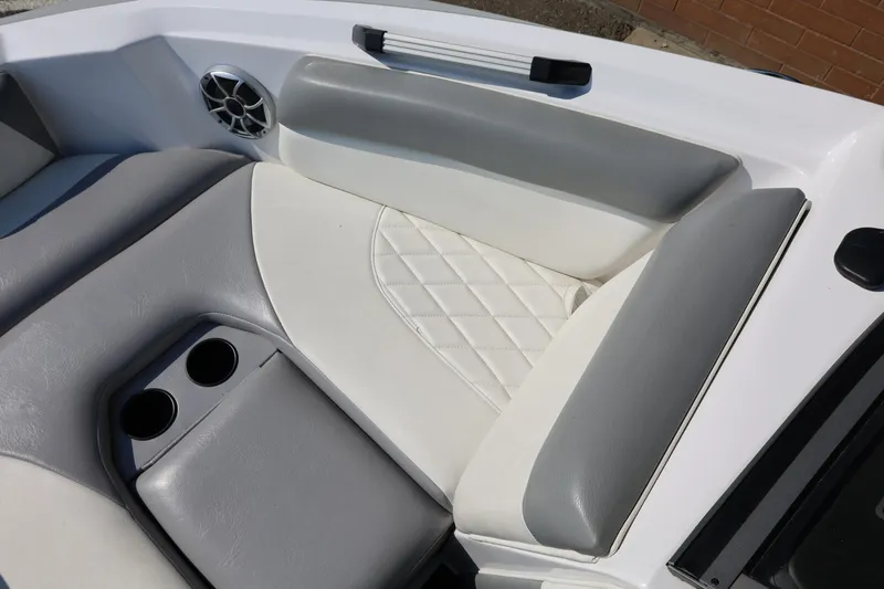 Slide: The Image of 2020 Tigé R20 boat interior with gray and white seating, cup holders, and speaker. - 44