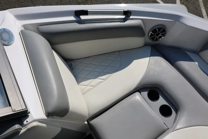 Slide: The Image of 2020 Tigé R20 boat interior with gray and white seating, cup holders, and speaker. - 43