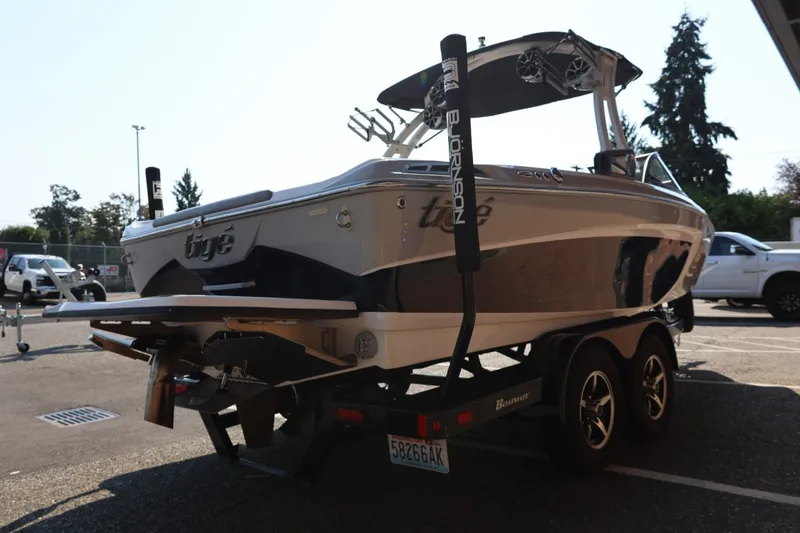 Slide: The Image of 2020 Tigé R20 boat on trailer, parked outdoors, showcasing sleek design and dual-axle trailer. - 9