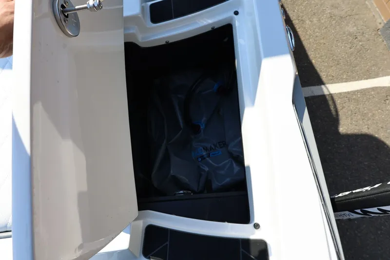 Slide: The Image of Open storage compartment in a 2020 Tigé R20 boat, showing interior space. - 21