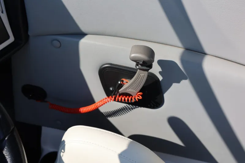 Slide: The Image of Interior view of a 2020 Tigé R20 boat with a throttle lever and safety lanyard. - 39