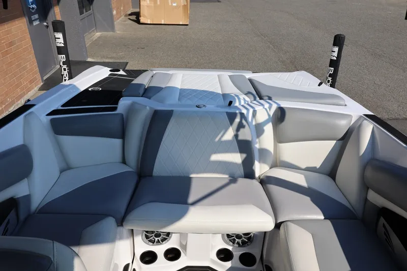 Slide: The Image of 2020 Tigé R20 boat interior with gray and white seating, cup holders, and speakers. - 31